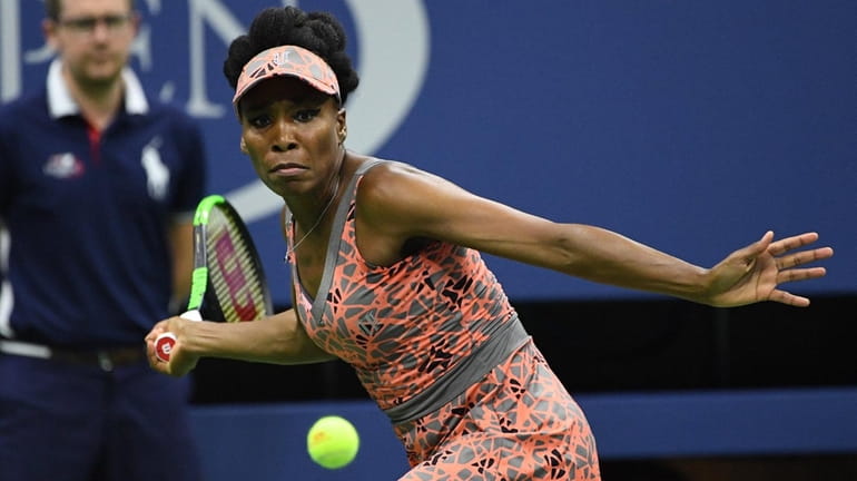 Venus Williams looks to return a shot to Oceane Dodin...