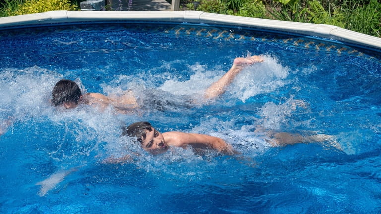 Tristan and Justin Rosenthal in their pool in Patchogue.