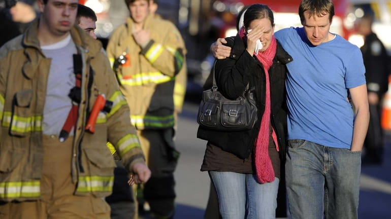 Victims family leave a firehouse staging area following a shooting...