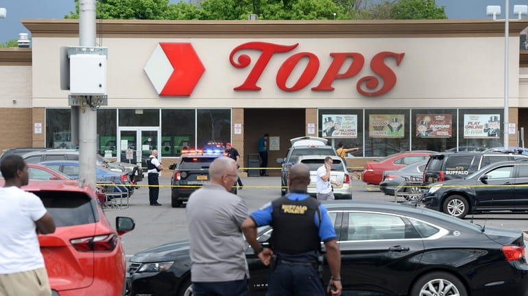 Police at the scene of the May 14 mass shooting...