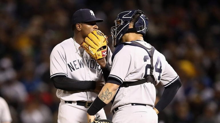 Luis Severino of the New York Yankees talks to catcher...