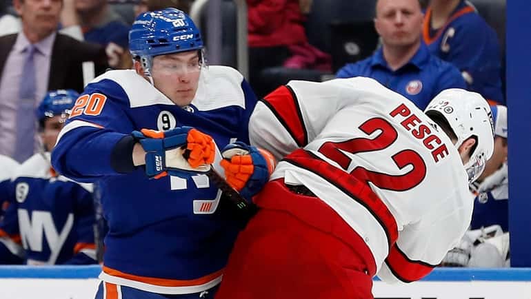 Kieffer Bellows of the Islanders and Brett Pesce of the Hurricanes collide...