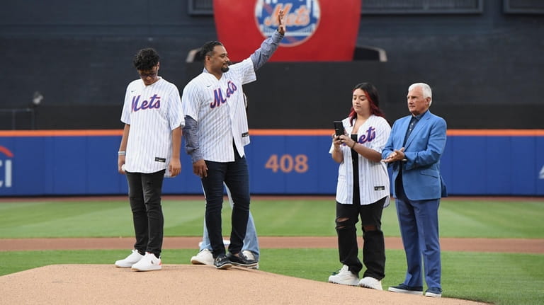 Former New York Mets pitcher Johan Santana, waves to fans...