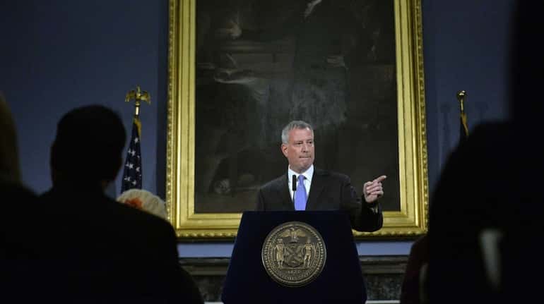 Mayor Bill de Blasio takes questions from the press during...