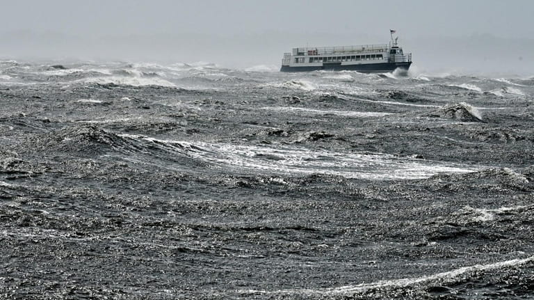 A ferry boat moves across the Great South Bay while...