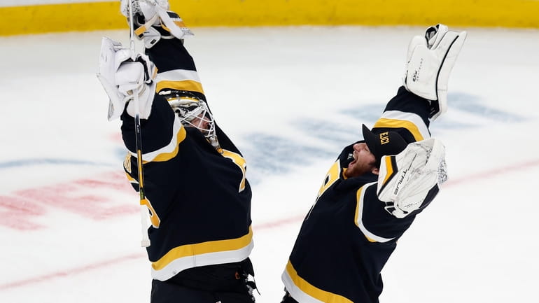 Boston Bruins' Linus Ullmark, left, and Jeremy Swayman celebrate after...