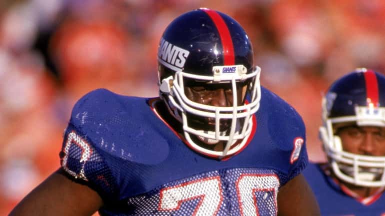 Defensive tackle Leonard Marshall #70 of the Giants stands on the...