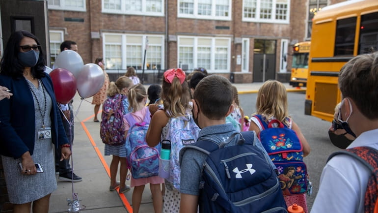 Students arrive at Stewart Elementary School on Tuesday, Sept. 8,...