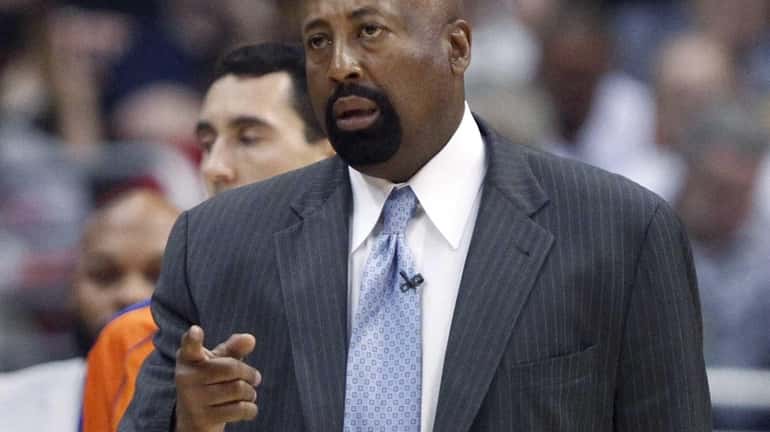 Knicks head coach Mike Woodson talks to an official in...