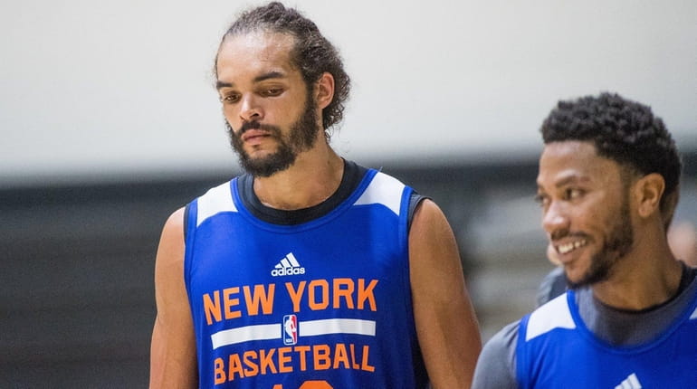 New York Knicks' Joakim Noah and Derrick Rose look on...