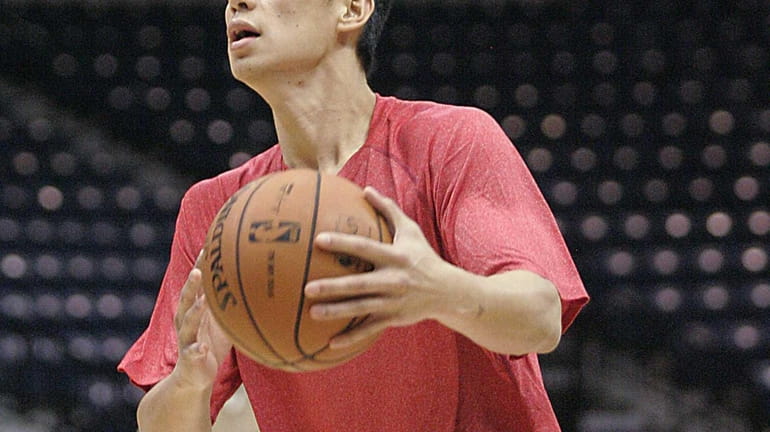Houston Rockets guard Jeremy Lin looks to get to the...