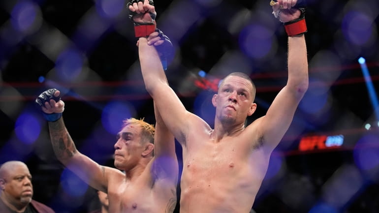 Nate Diaz, right, celebrates after defeating Tony Ferguson in a...