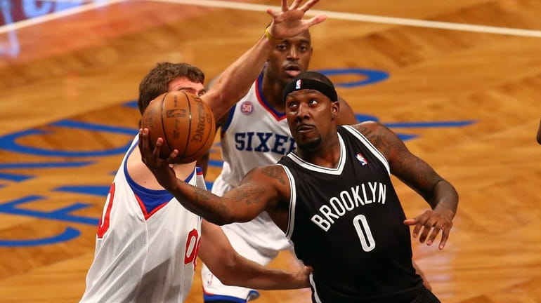 Andray Blatche drives to the hoop against Spencer Hawes and...
