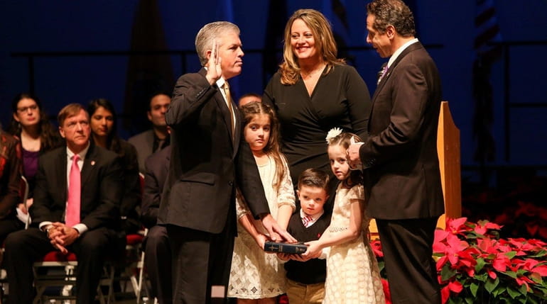 Suffolk County Executive Steve Bellone is sworn in for his...