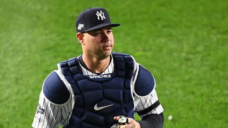 Yankees catcher Gary Sanchez runs into the outfield before Game...