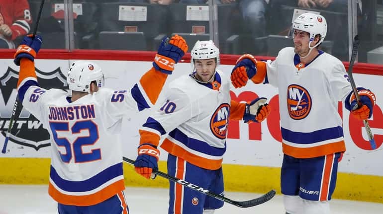 New York Islanders center Brock Nelson, right, celebrates with center...