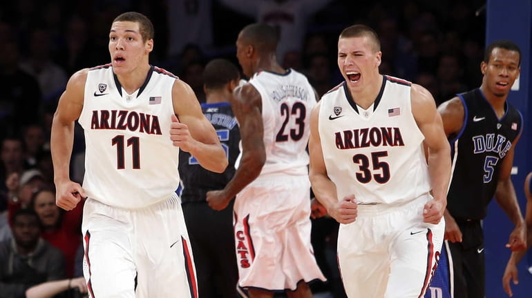Arizona's Aaron Gordon (11) and Kaleb Tarczewski (35) react after...