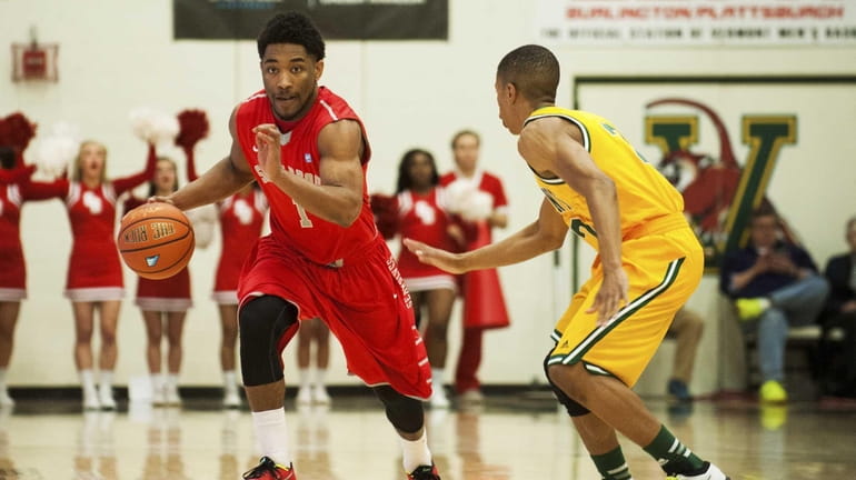 Stony Brook's Deshaun Thrower, left, moves downcourt during the America...