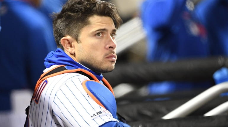 Mets catcher Travis d'Arnaud looks on from the dugout against...