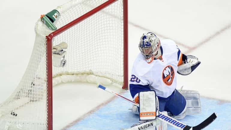 New York Islanders goalie Evgeni Nabokov gets beat for a...