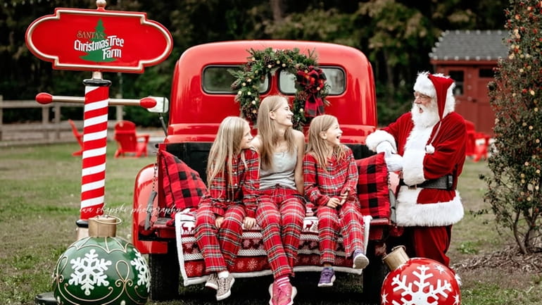 A trio of young guests visiting Santa's Christmas Tree Farm...