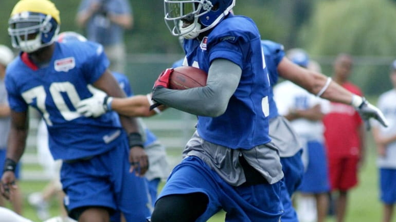 The Giants' Aaron Ross fields a punt during training camp.
