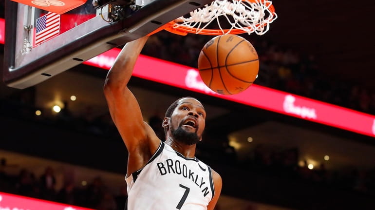 Kevin Durant of the Brooklyn Nets dunks during the first...