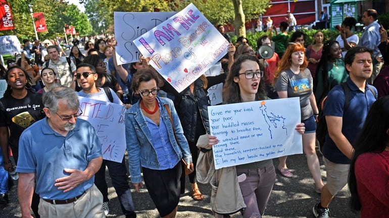 Students and immigrant advocates march on the campus of Stony...
