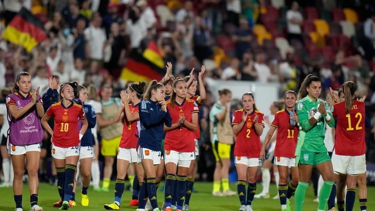 FILE - Spain players applaud the fans at the end...