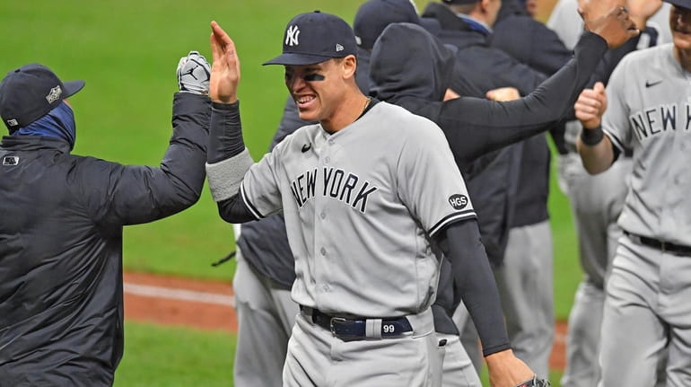 Aaron Judge of the Yankees celebrates with a teammate after the Yankees...
