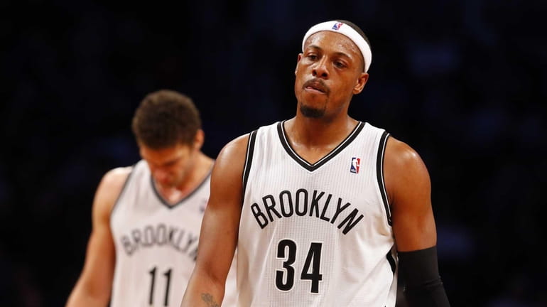 Paul Pierce and Brook Lopez of the Nets look on...