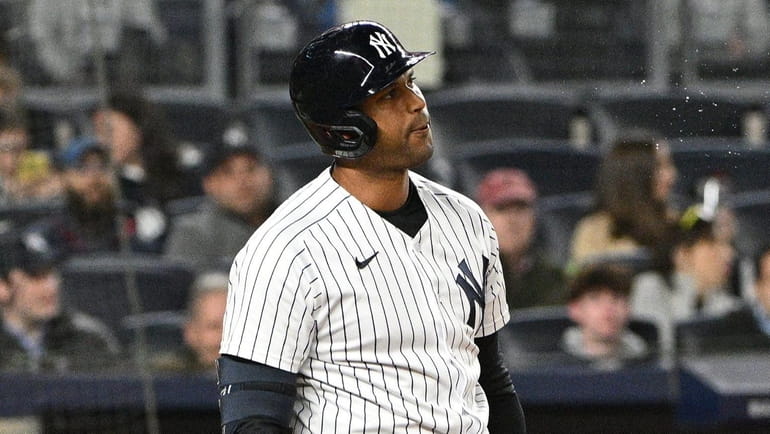 Yankees leftfielder Aaron Hicks reacts after he struck out swinging...