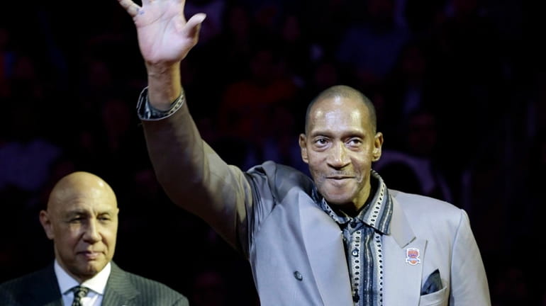 Harthorne Wingo waves to the crowd as teammate Henry Bibby,...