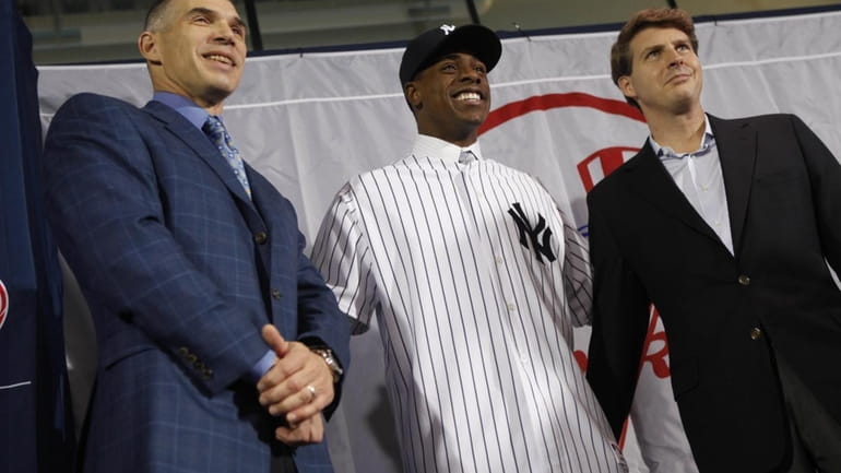 Curtis Granderson, center, the newest New York Yankees player, poses...