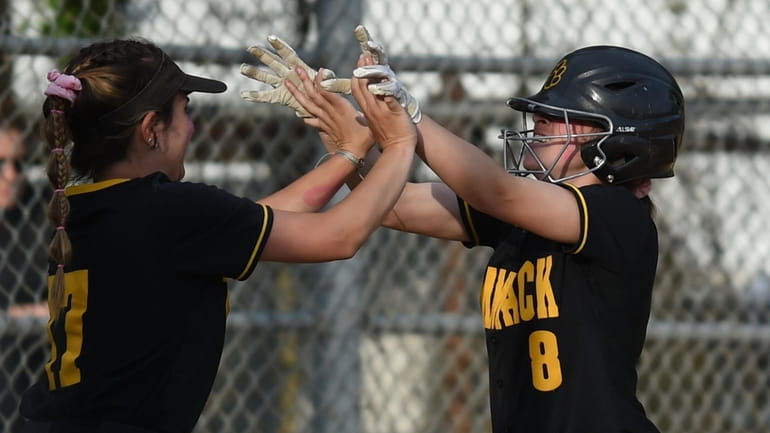 Rachel Abzug #8 of Commack, right, gets congratulated by Michelle...