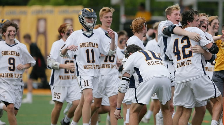 Shoreham-Wading River celebrates its win in the state Class C...
