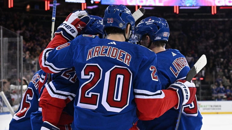 Rangers players celebrate a goal by center Vincent Trocheck against...