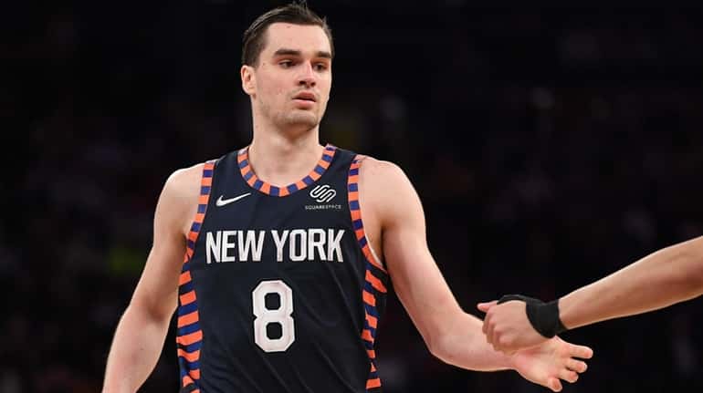 Knicks forward Mario Hezonja reacts with a teammate after a...