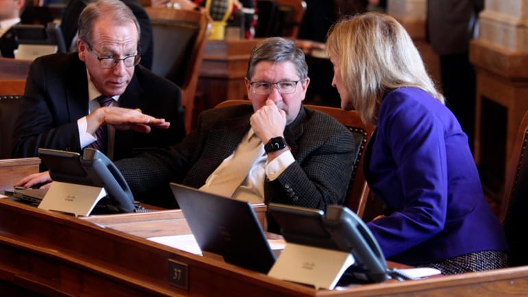 Kansas state Reps. Mark Schreiber, left, R-Emporia; Carl Maughan, center,...