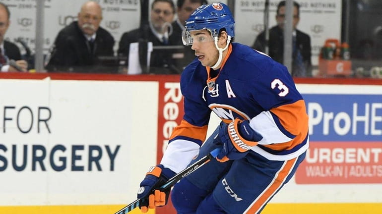 New York Islanders defenseman Travis Hamonic skates with the puck...