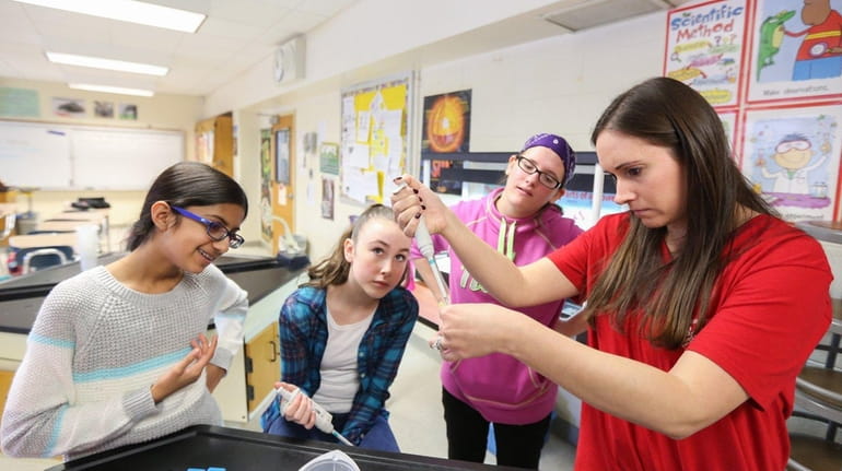 From right, Danielle Whitcomb helps her 7th-grade students Ashley Adaszewski,...