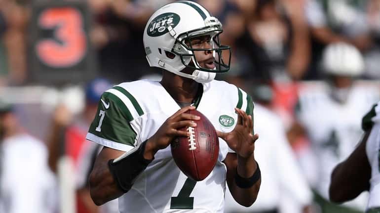 Geno Smith of the New York Jets looks to pass...