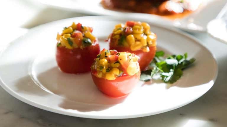 A plate of Spicy Corn Relish Stuffed Tomatoes featuring Stonewall Kitchen's...