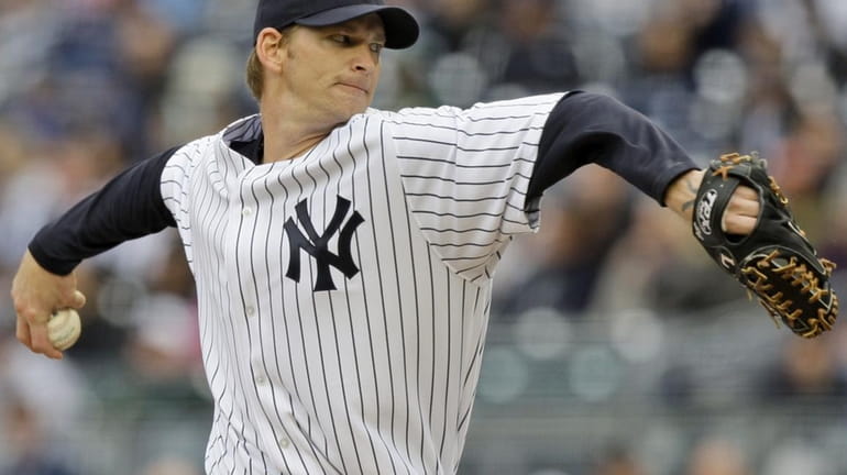New York Yankees' A.J. Burnett delivers a pitch during the...
