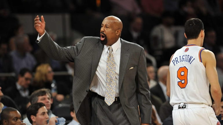 Mike Woodson yells at his team early in the game...