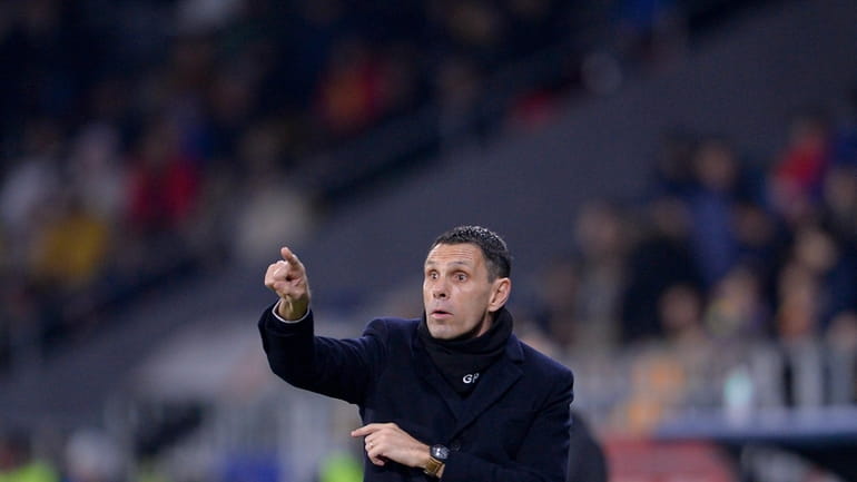 Greece's head coach Gus Poyet gives instruction from inside the...
