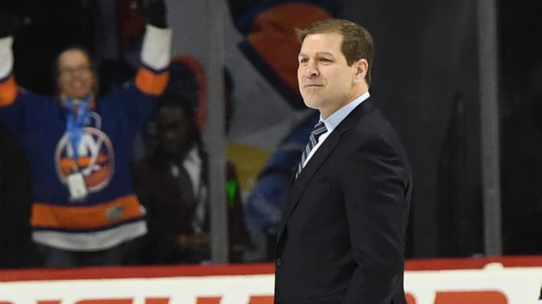 New York Islanders interim head coach Doug Weight walks off...