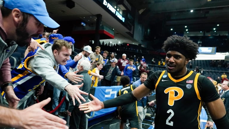 Pittsburgh's Blake Hinson celebrates with fans after Pittsburgh defeated Mississippi...