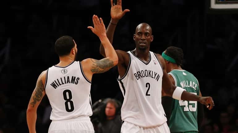 Kevin Garnett and Deron Williams of the Nets celebrate a...