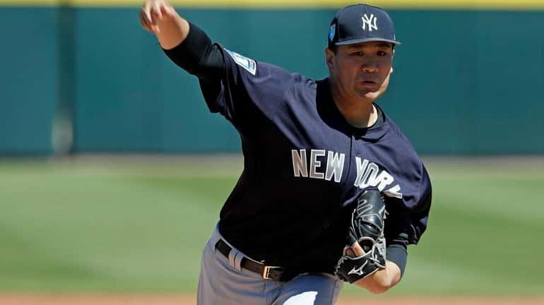 Yankees pitcher Masahiro Tanaka throws in the first inning of...